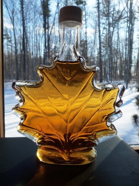Decorative maple leaf bottle of put Wisconsin maple syrup.